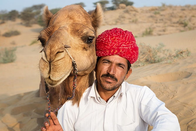 Portait of man with turban and camel, Thar Desert (Sam Sand Dunes), Jaisalmer, Rajasthan
